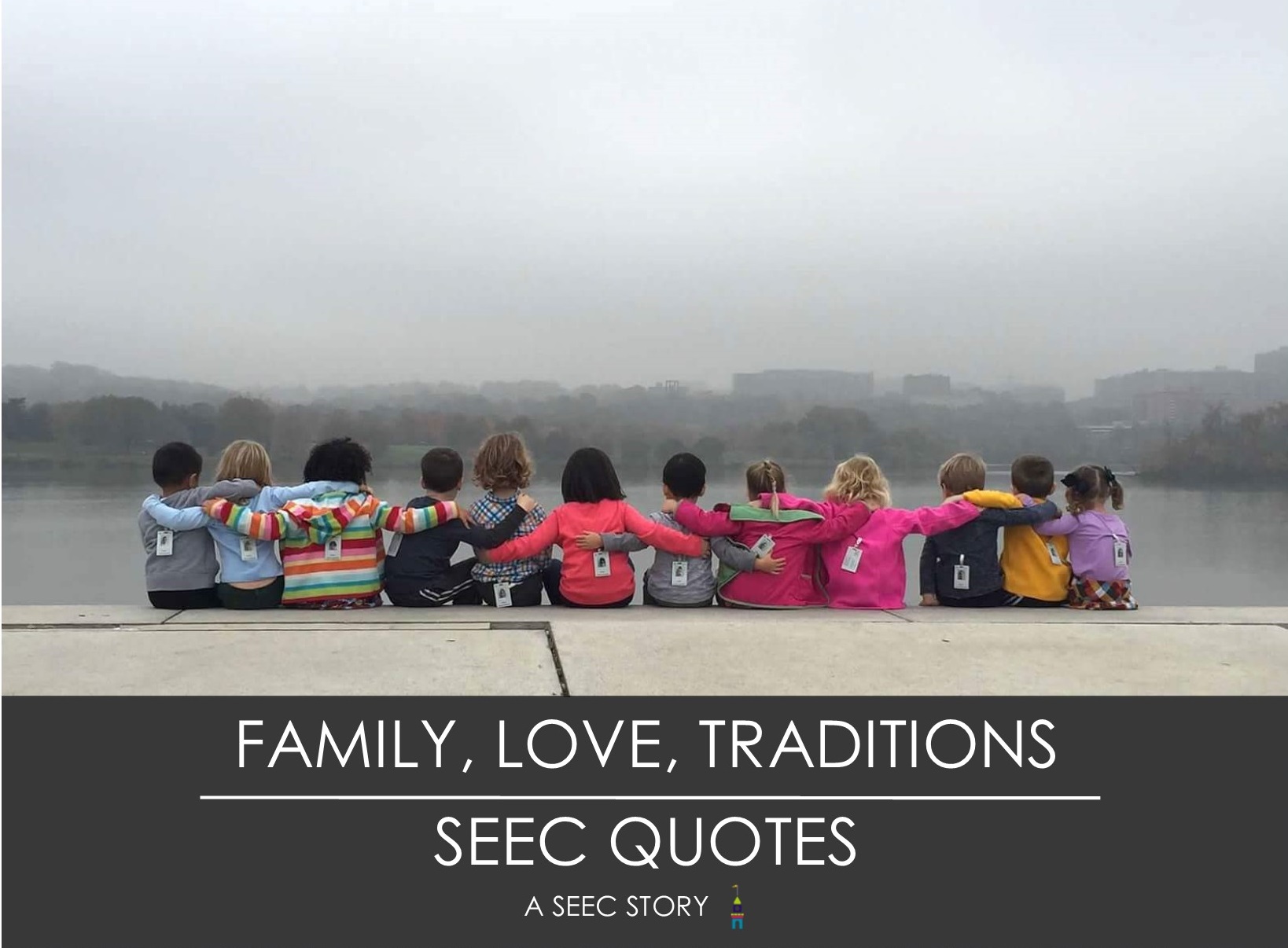 Children sitting in front of river with their arms around each other.